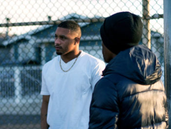 Three men talking in neighbordhood