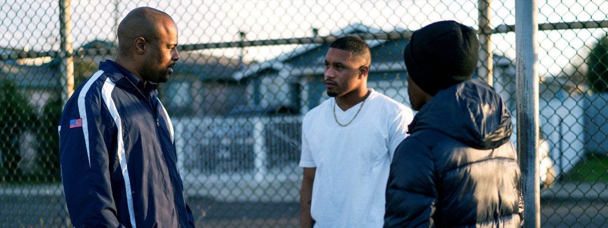 Three men talking in neighbordhood