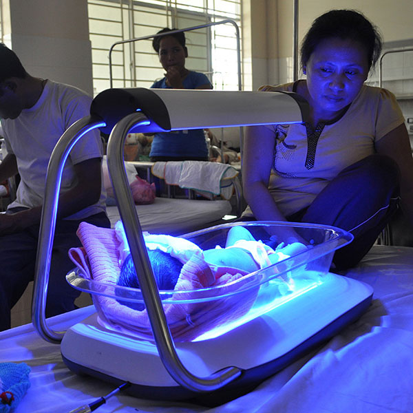 Baby under blue light incubator
