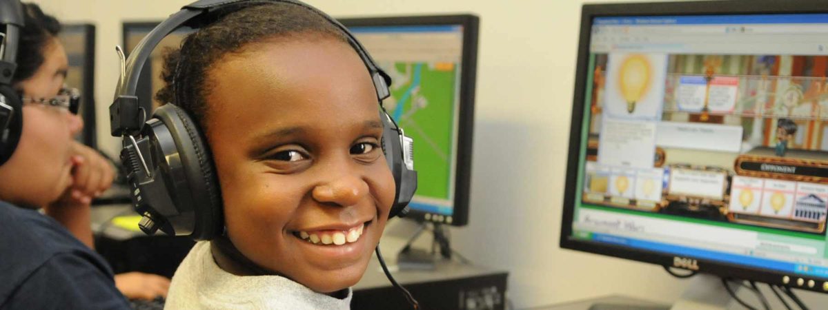 Young boy playing iCivics game on computer