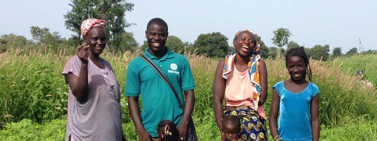 Family of farmers standing in a field