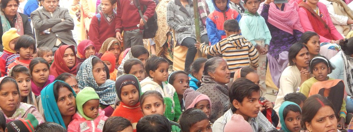 Large group of Indian students sit on the floor