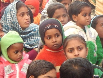 Large group of Indian students sit on the floor