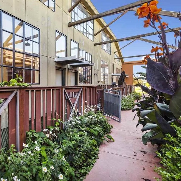Image of the outside of a home with walkway and flowers