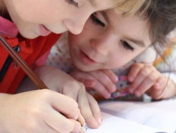 Girls drawing with colored pencils