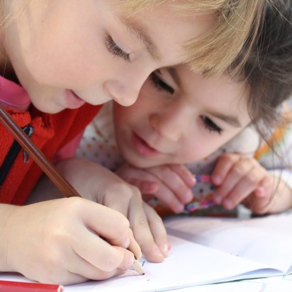 Girls drawing with colored pencils