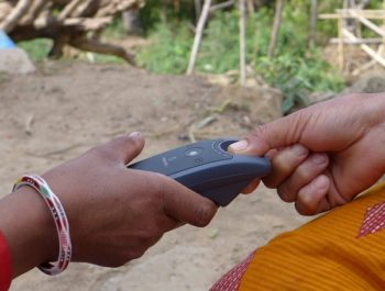 Finger being scanned in village