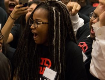 Young woman cheers while wearing a Braven t-shirt