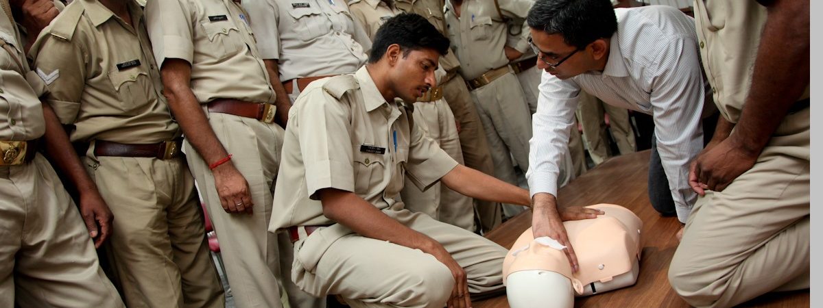 A classroom of Indian men learn CPR
