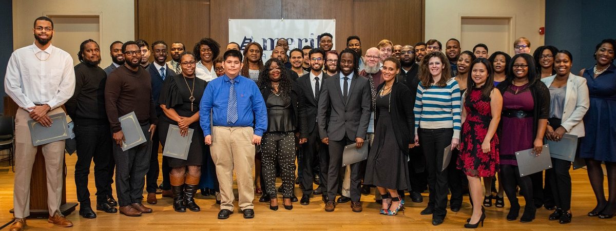 A huge group of recent graduates gather and smile at their Beta Cohort Graduation