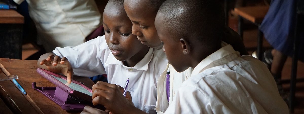 3 students work together on an ipad