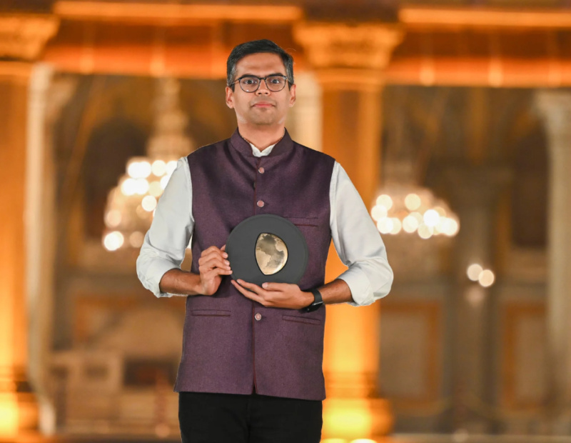 A man holds an award