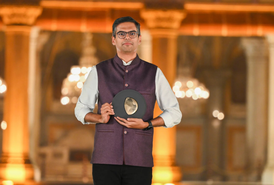 A man holds an award