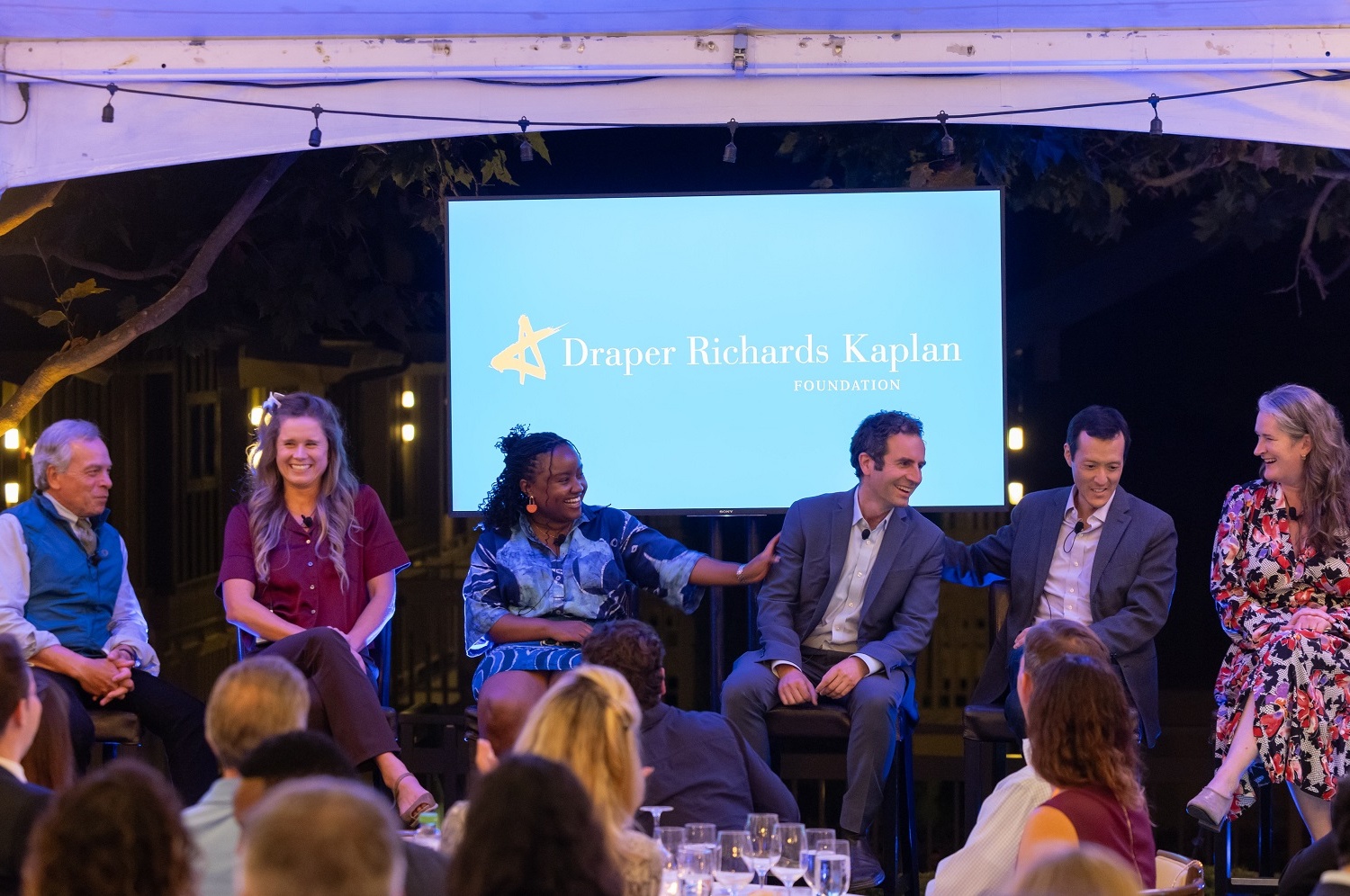 A panel sits on stage with a DRK logo backdrop