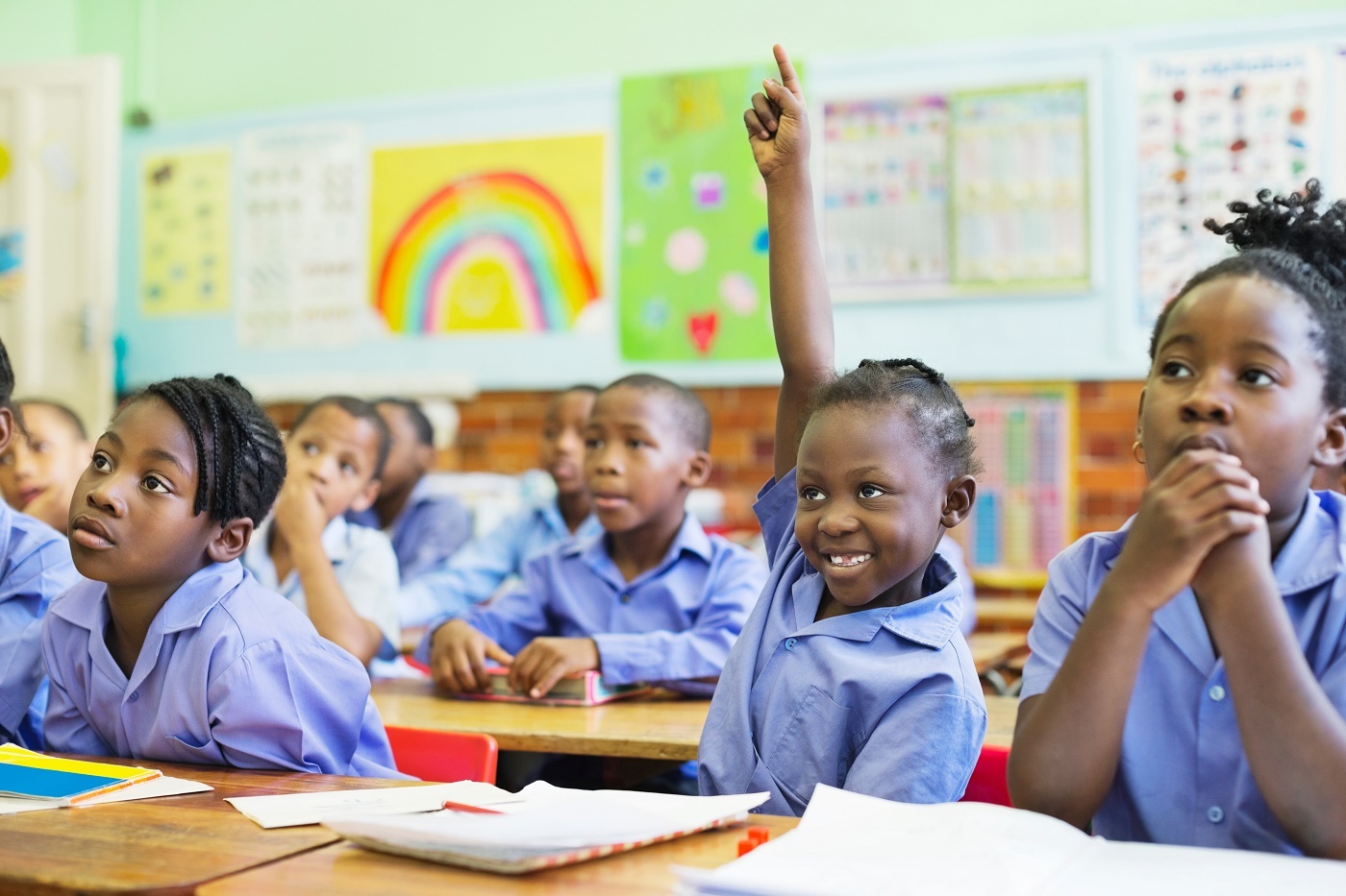 Student raising hand in class