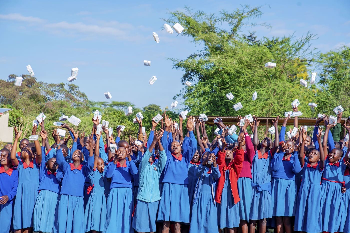 African children raise their arms outside