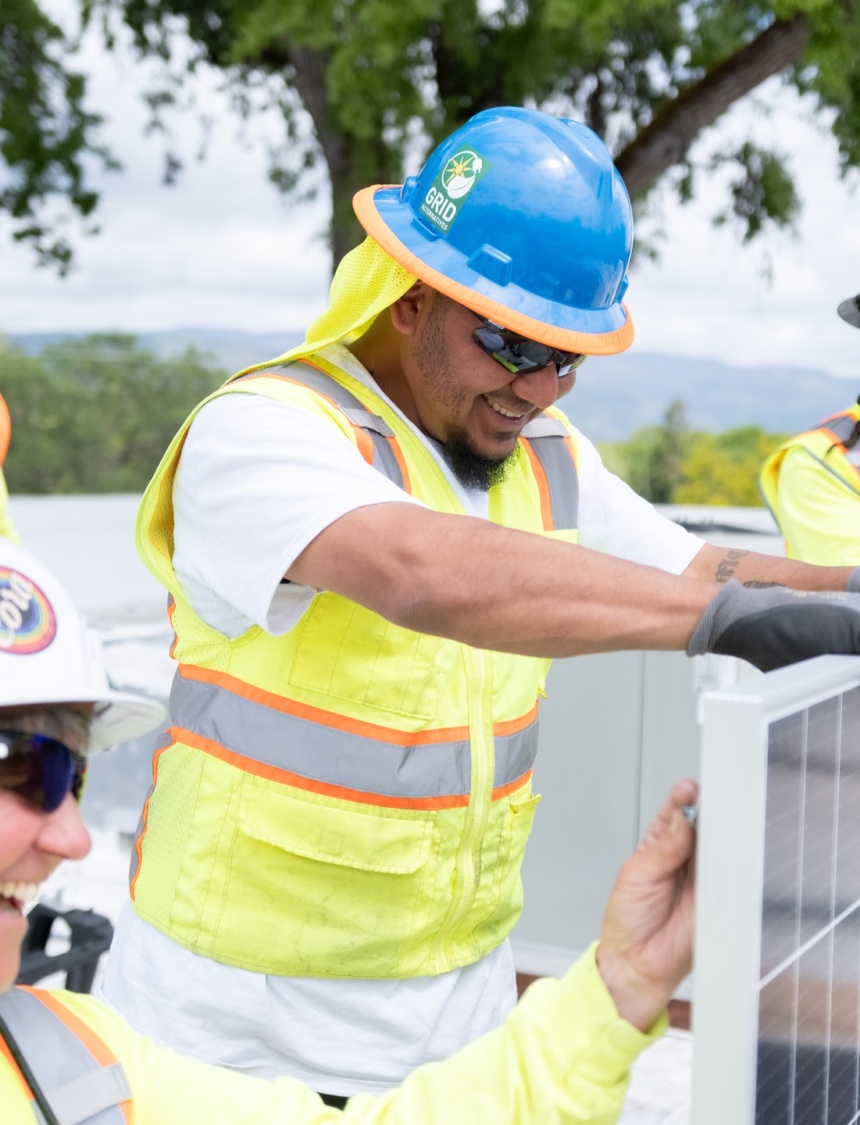 People work together to install solar panels