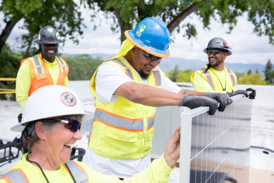 People work together to install solar panels