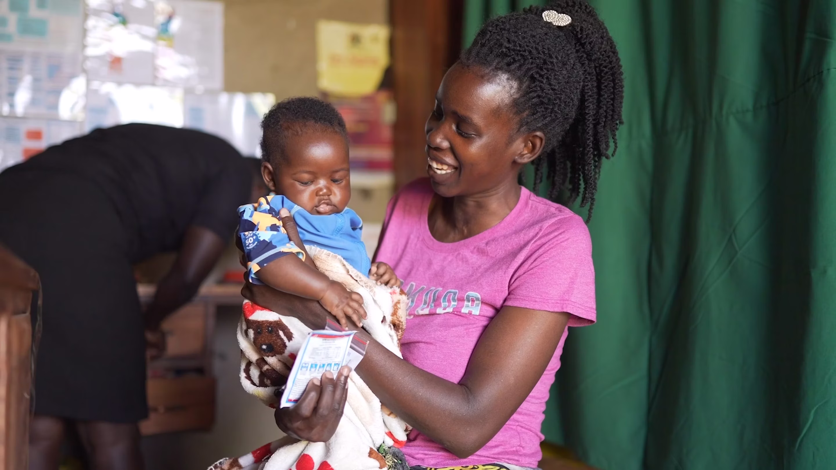 An Africa mother holds up her happy baby
