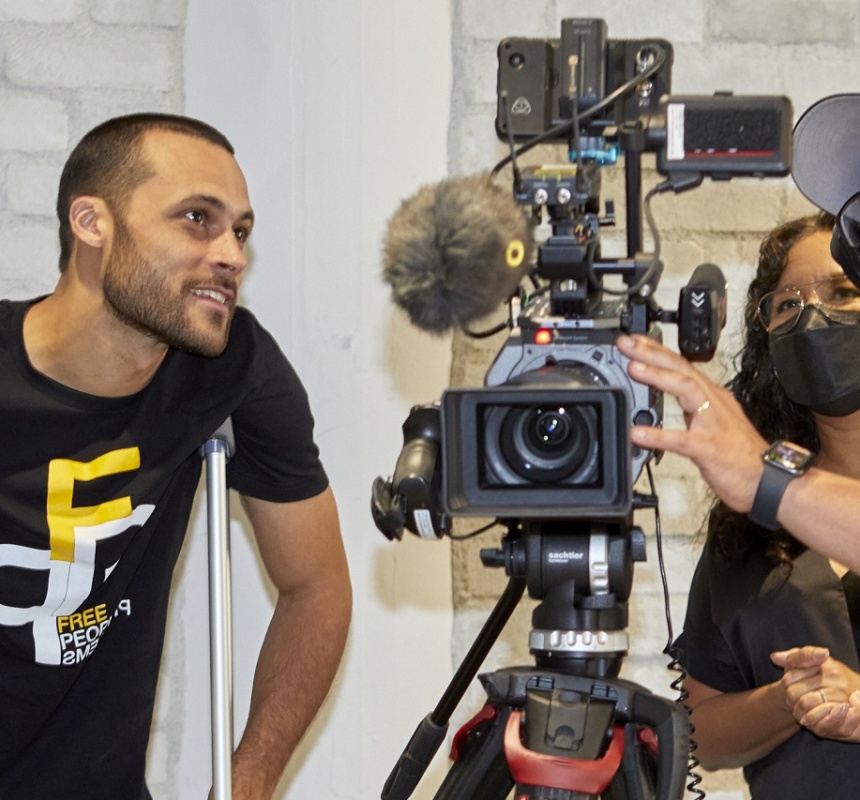 Three people film with professional equipment