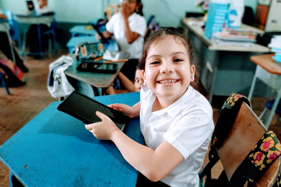 A student smiles in the classroom