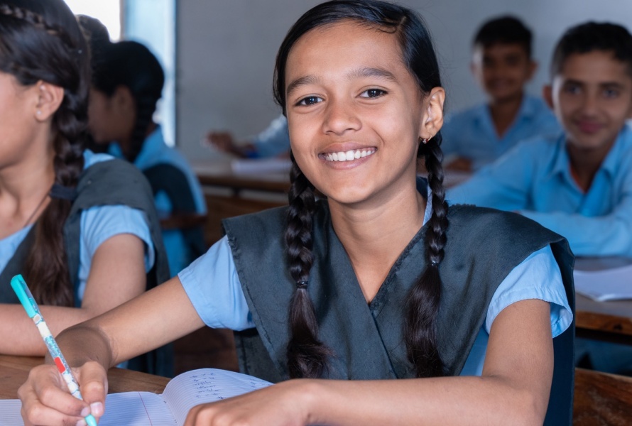 Group of indian village students in school uniform sitting in classroom studying. Selective Focus, Education concept