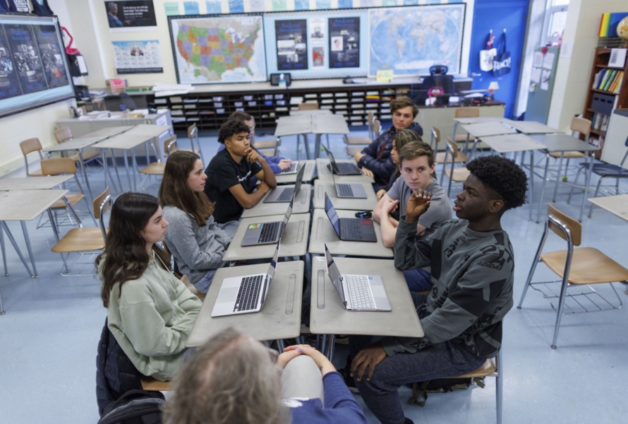 Students and Social Studies teacher Mary Robb discuss recent news articles as reported on from left, center and right leaning news organizations, during class at Andover High School in Andover, Massachusetts, USA