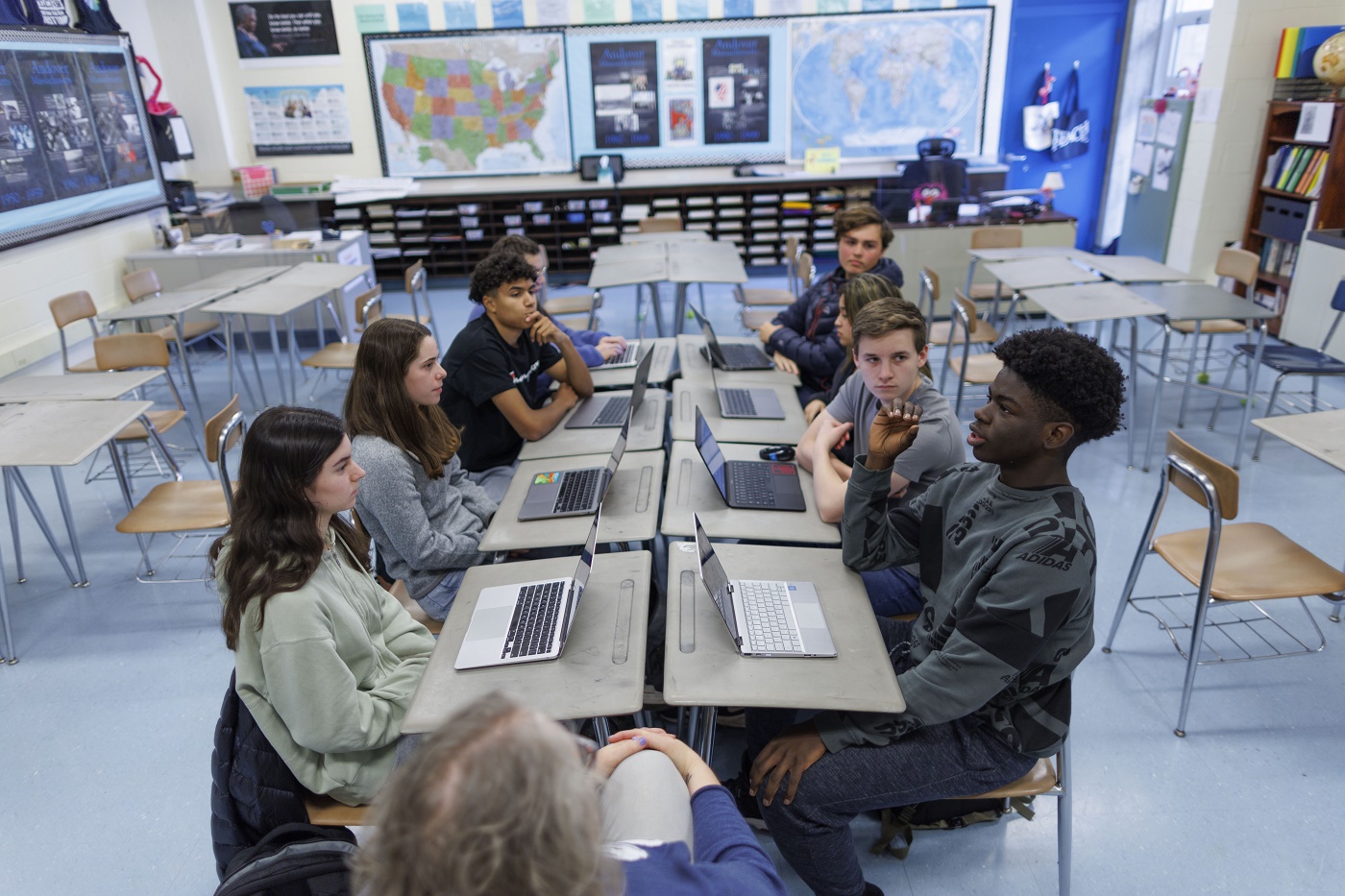 Students and Social Studies teacher Mary Robb discuss recent news articles as reported on from left, center and right leaning news organizations, during class at Andover High School in Andover, Massachusetts, USA